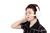 Portrait of a happy young boy listening to music on headphones