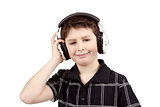 Portrait of a happy smiling young boy listening to music on headphones