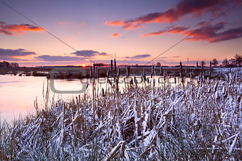 dramatic sunrise over frozen lake