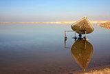 Dead Sea view with a canoe and reflection