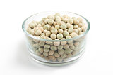 Collection of dried peas in transparent glass bowl