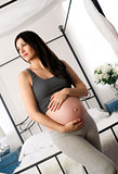 Brunette Woman Smiling Shows Pregnant Belly Standing Near Canopy