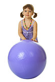 Little girl with a large rubber ball on white