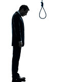 man sad standing in front of  hangman noose silhouette