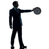 business man holding clock silhouette