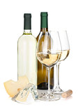 White wine bottles, two glasses, cheese and corkscrew