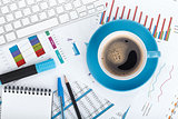 Blue coffee cup on financial papers
