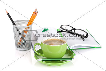 Green coffee cup, glasses and office supplies
