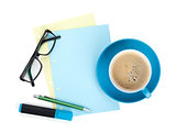 Blue coffee cup, glasses and office supplies
