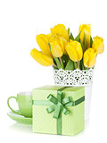Yellow tulips, tea cup and gift box