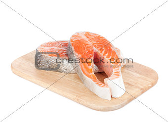 Salmon steaks on cutting board