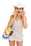 Happy beach young woman shouting through megaphone shaped hands