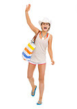 Happy beach young woman saluting