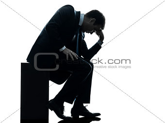 sad business man sitting pensive silhouette