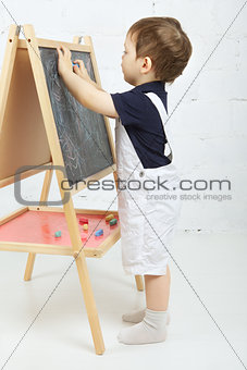 Child Drawing With Chalk