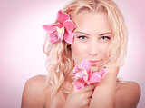 Blond woman with pink orchid