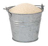 Golden granulated sugar in a miniature metal bucket
