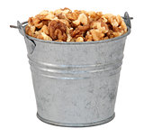 Chopped walnuts in a miniature metal bucket