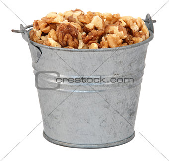 Chopped walnuts in a miniature metal bucket