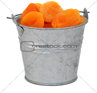 Dried apricots in a miniature metal bucket