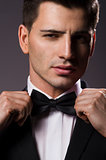 Close-up portrait of a young handsome man with bow tie