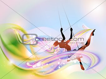 Young woman on the swing in springtime