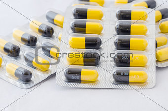 Black and yellow capsule