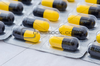 Black and yellow capsule