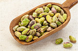 raw pistachio nuts on a scoop