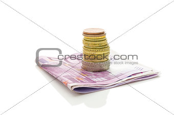 Stack of Euro coins on banknotes