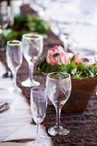 Wine and champagne glasses on a table with protea flowers
