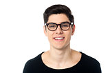 Smiling cool handsome young guy in eyeglasses