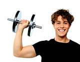 Powerful muscular young man lifting weight