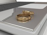 Two wedding rings on a laptop 