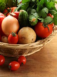 fresh vegetables and herbs mix in a wicker basket