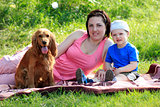 Mother, child and dog on picnic