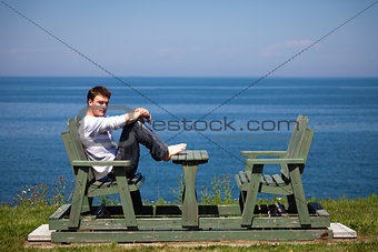 Young man sitting on the bench