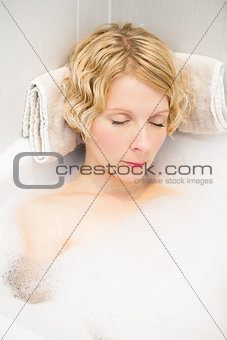 Young woman sleeping in the bath