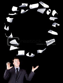 Businessman manipulating sheets of paper