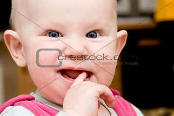child with finger in the mouth