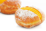 Two Berliner with egg creme over white