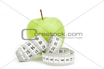 Measuring tape and green apples as a symbol of diet