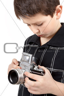 young boy with old vintage analog SLR camera