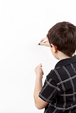 young boy student in a writing on a whiteboard