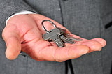 man in suit showing a key ring