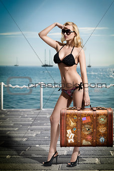 sexy blonde tourist with vintage bag