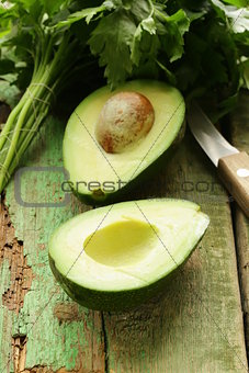 ripe avocado cut in half on a wooden table