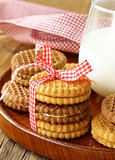 homemade cookies (sandwich) with milk on a wooden table