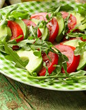 avocado salad with arugula, tomato and olive oil