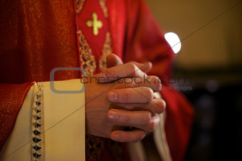 Catholic priest on altar praying during mass